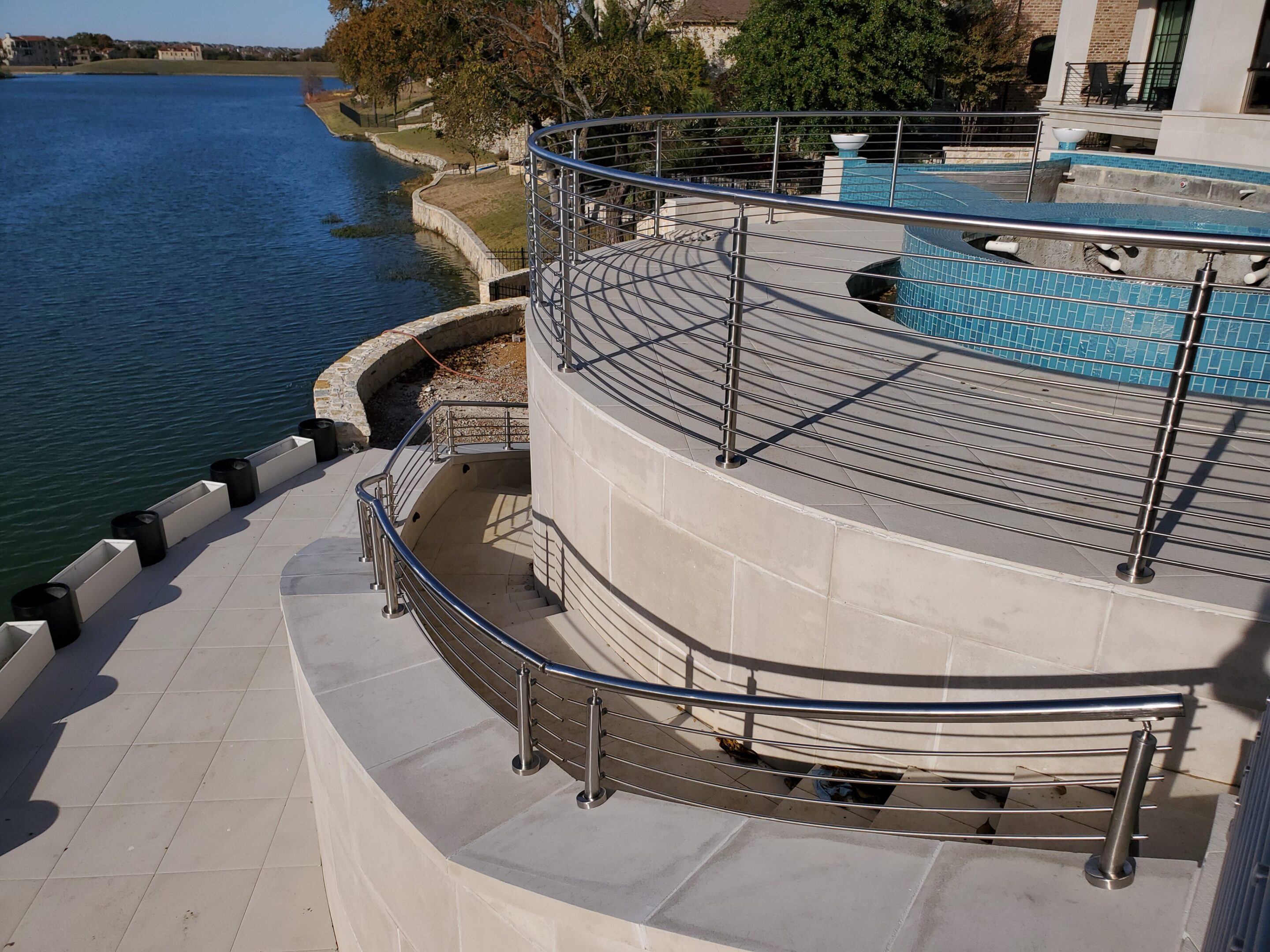 A pool with stairs and a railing around it.