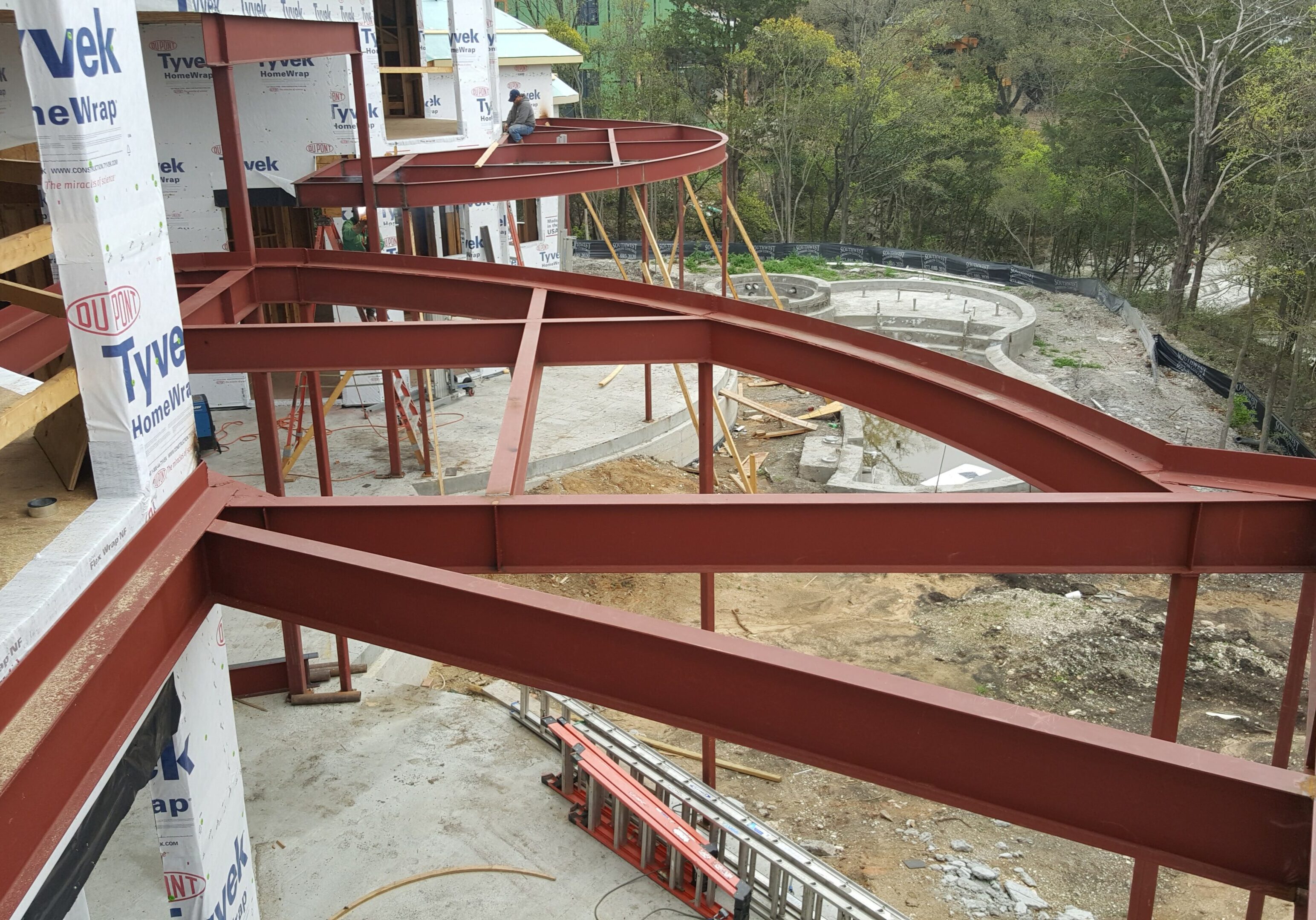 A red metal structure is being built.