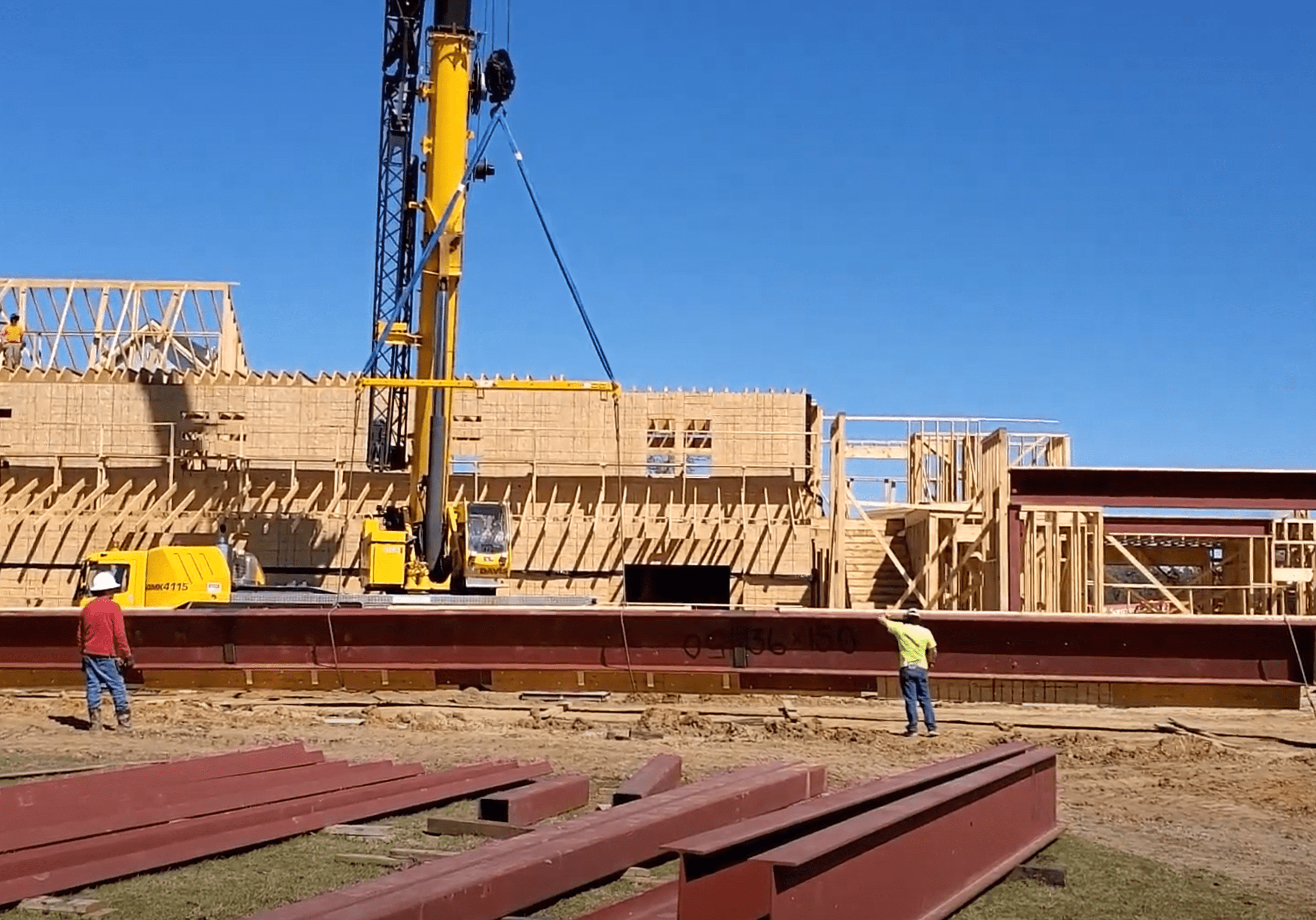 A construction worker standing in front of a building.